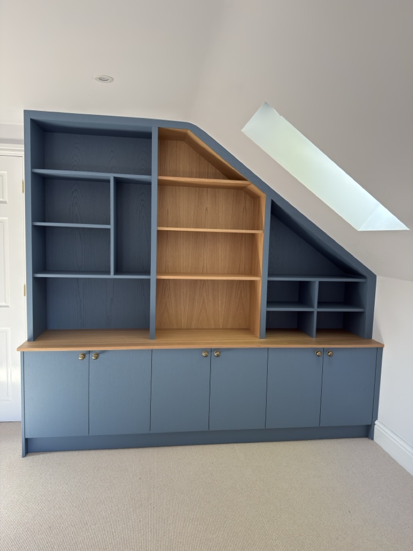 Watermill Lodge — blue and oak under-eaves shelving detail