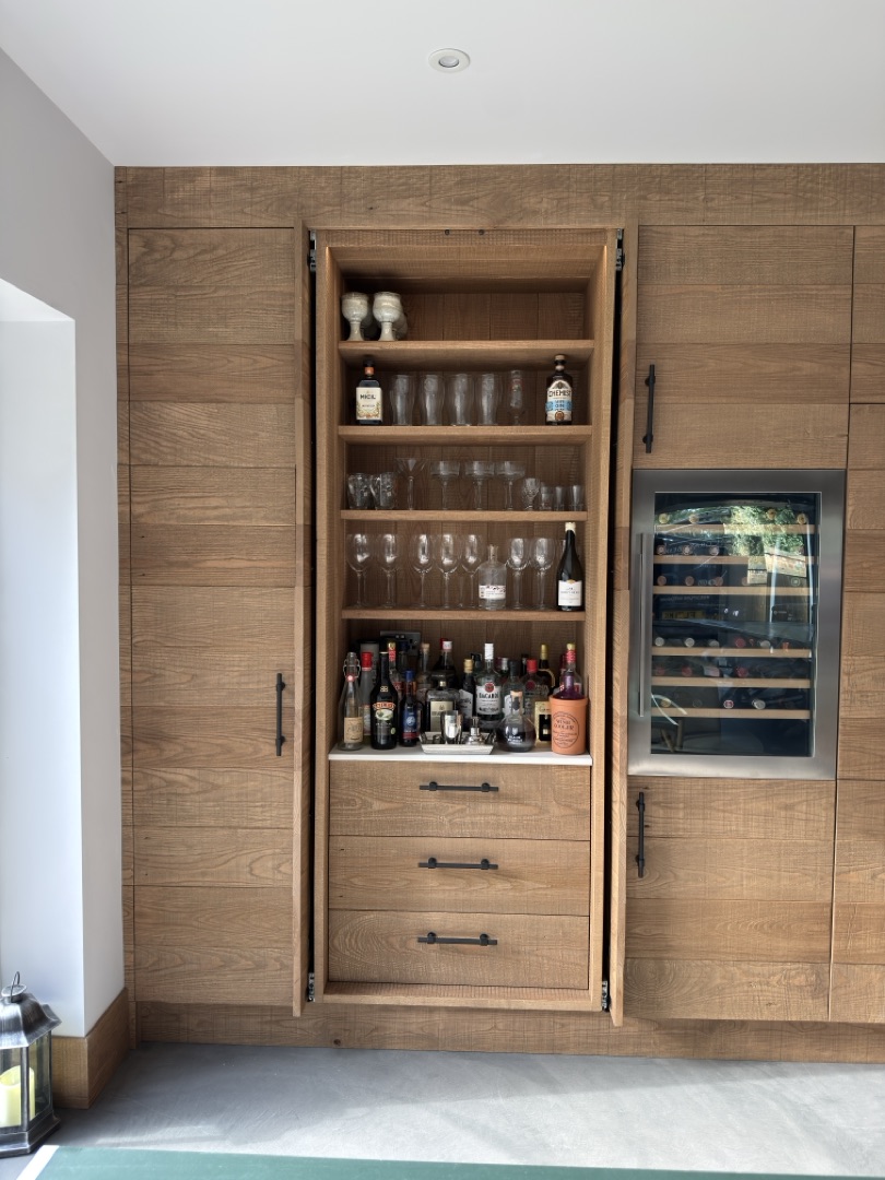 Watermill Lodge — full-height drinks cabinet with oak-lined interior, open