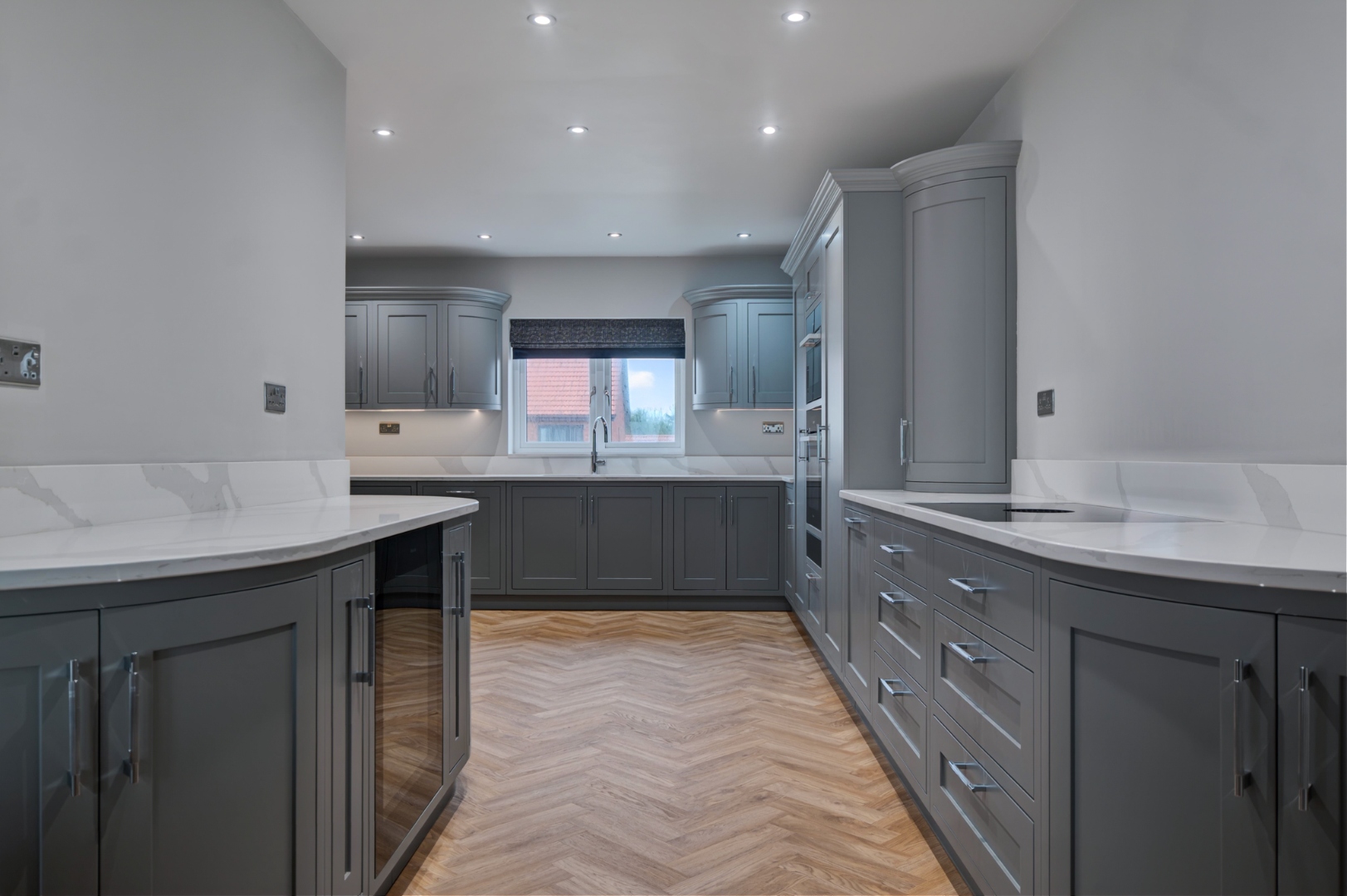 Bespoke in-frame shaker kitchen in blue-grey with marble worktops and herringbone oak flooring — Grays Bespoke Interiors, East Yorkshire