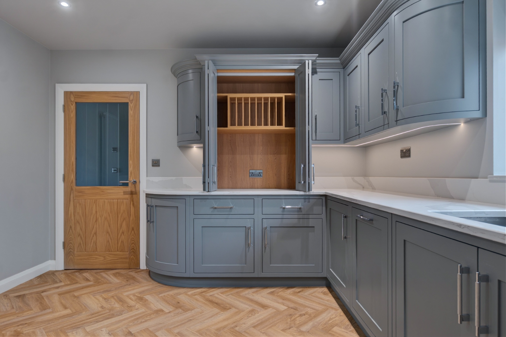 Open larder cabinet with plate rack and bi-fold doors — bespoke kitchen storage