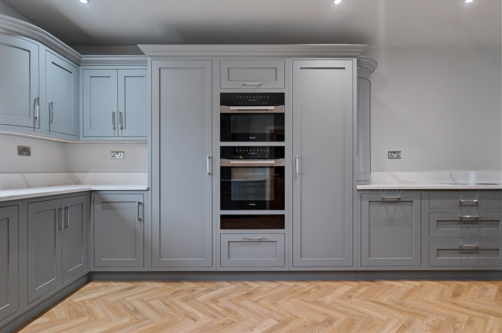 Integrated Miele appliance tower in bespoke kitchen — built-in ovens and microwave
