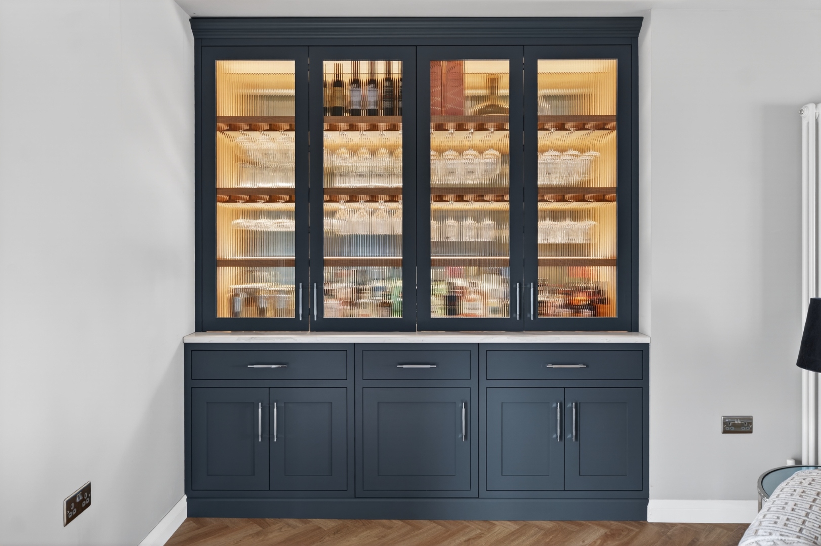 Belvedere Parade — navy drinks cabinet with reeded glass doors, closed