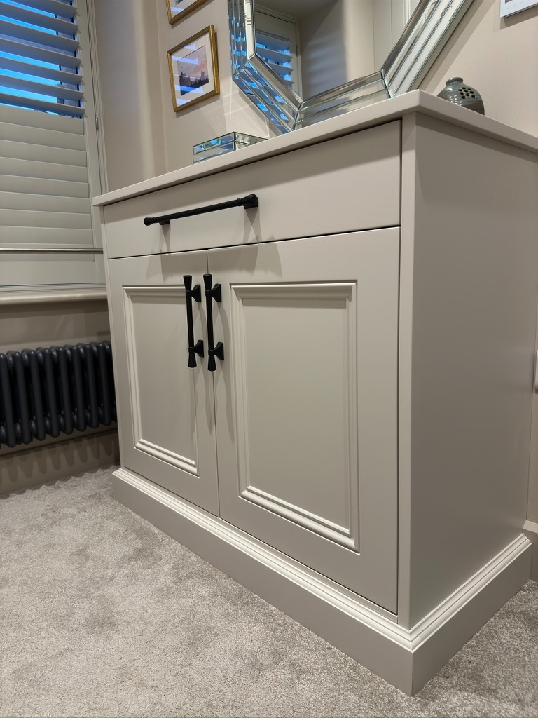 Bespoke vanity unit with shaker doors, drawer, and black handles
